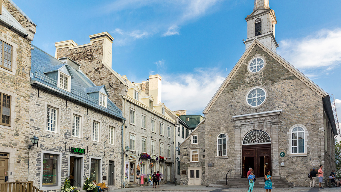 People standing outside of an old church in Old Quebec City