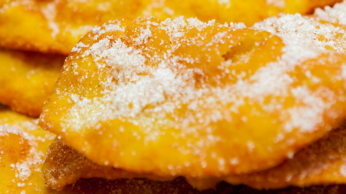 A flat dough pastry covered in cinnamon and sugar.