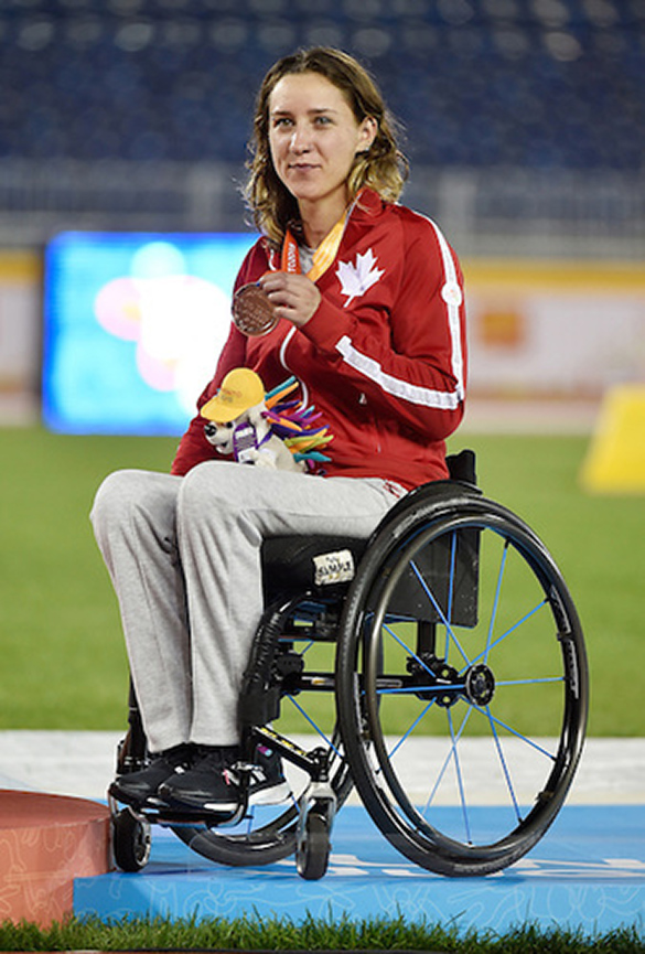 An Olympic athlete holds her medal.