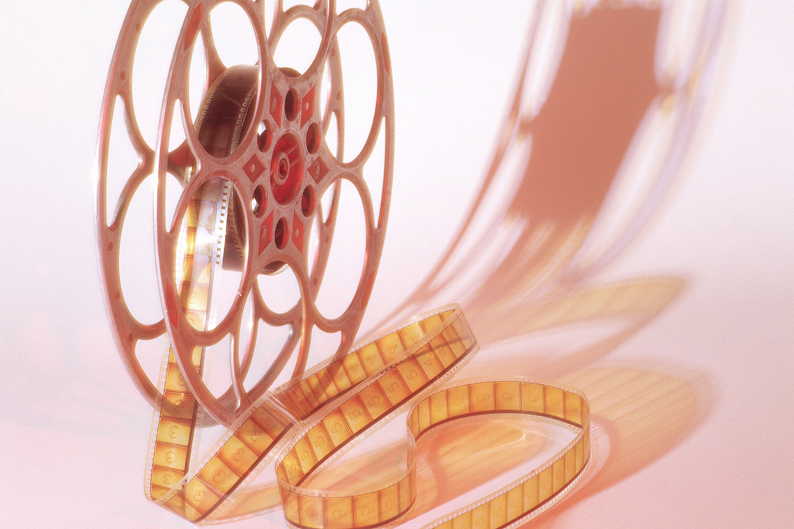 A reel with film spinning out.