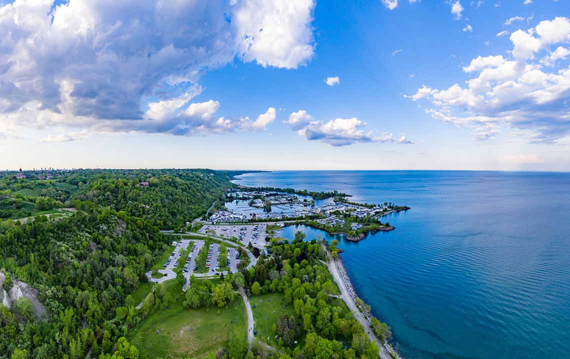 Aerial image of Lake Ontario, showing Scarborough, ON shoreline. Seen is a path, trees, parking lot, and a few small inlets