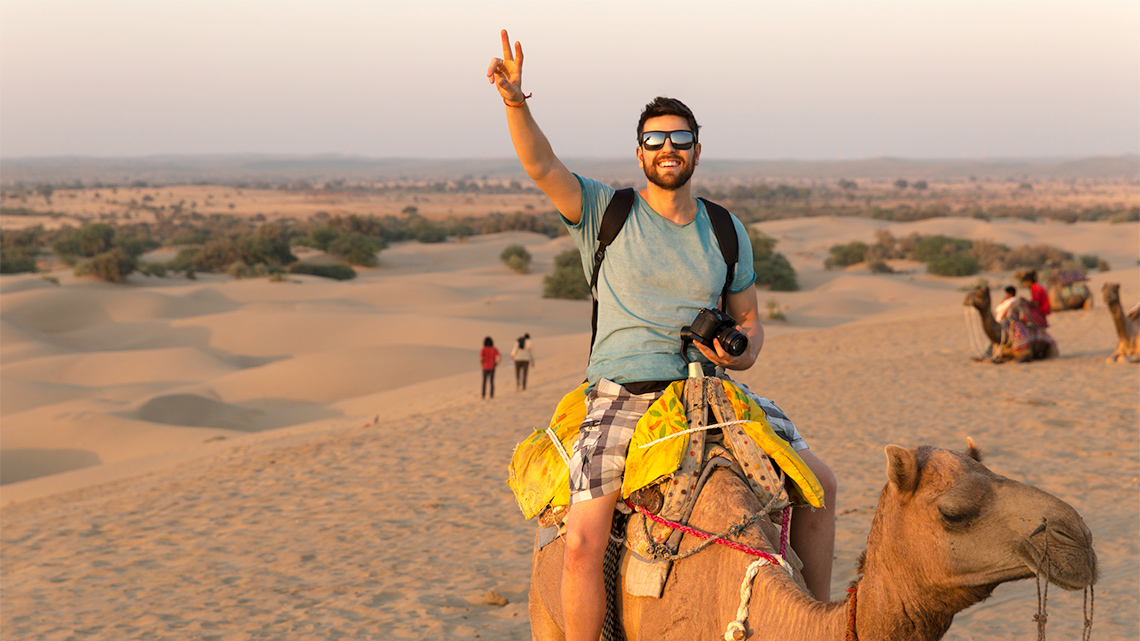 A tourist riding on a camel