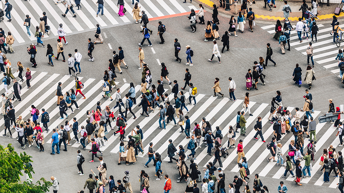 A Dense Crowd of People Crossing a Street in Tokyo, Japan A dense crowd of people crossing a street in Tokyo, Japan.