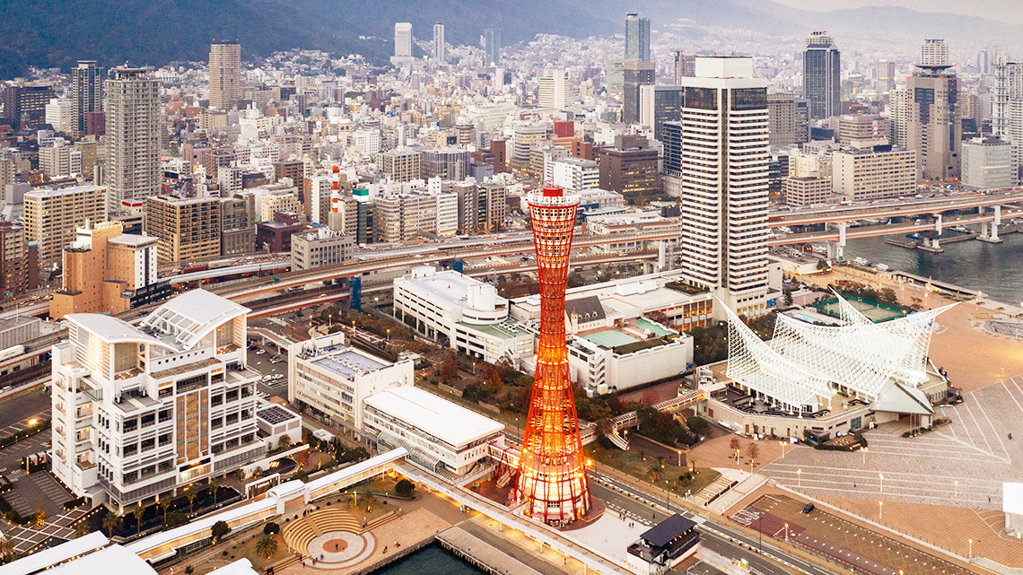 An aerial image of Kobe, Japan with skyscrapers filling every space including the artificial island.