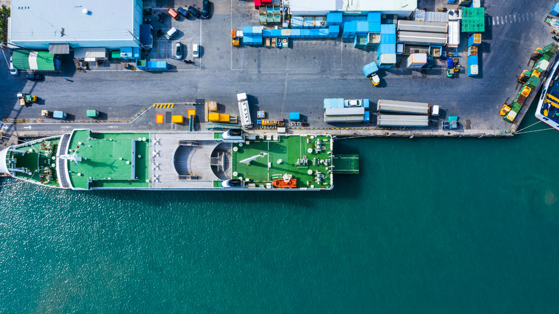 Loading Up a Ship in a Japanese Port An aerial image of a large ship being loaded with goods in a Japanese port.