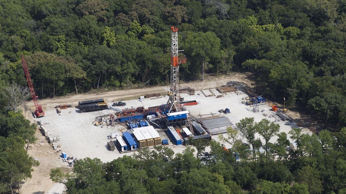 The facility is in the shape of a rectangle and has drilling and other types of machinery on it.