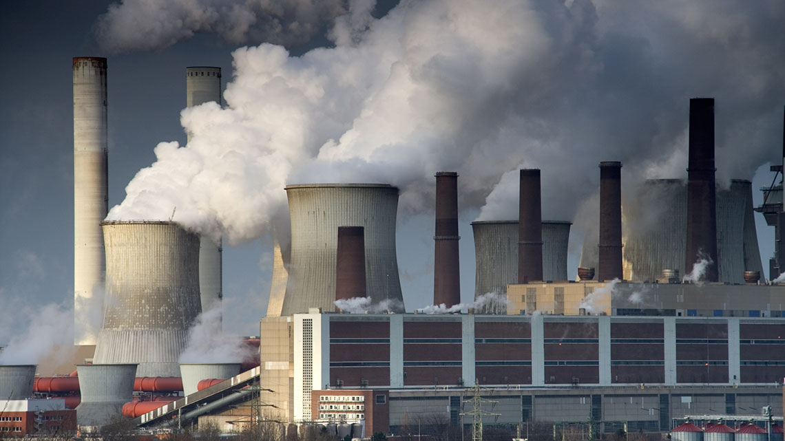 Pollution can be see coming from smokestacks near an open pit mine in Germany.