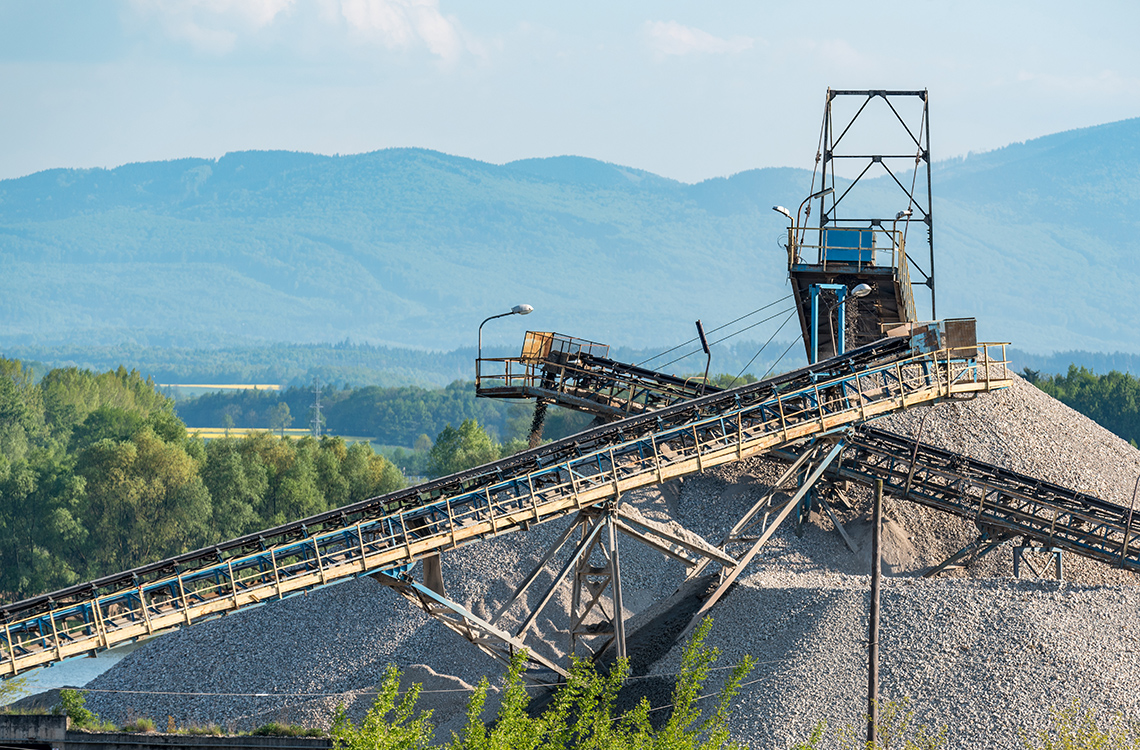 A coal refinery. There are two large piles of coal near mineral elevators that transport the coal.