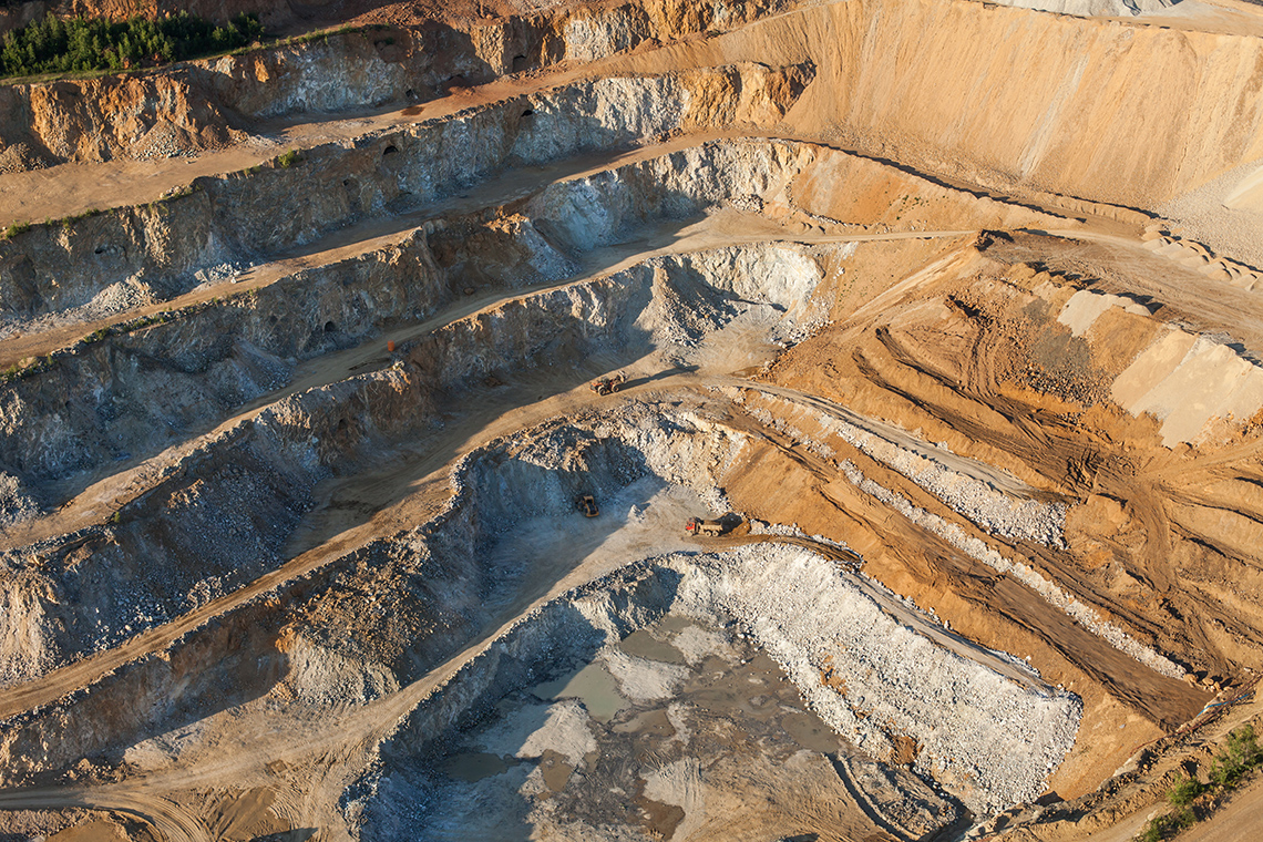 The image shows an iron mine. The image shows a landscape that has been dramatically reshaped.