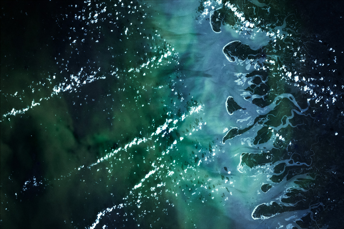 The image of a body of water changing from one kind of water to another.