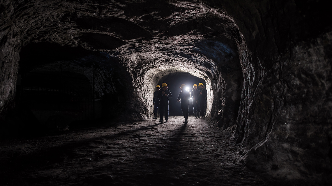 A group of people in an underground mine.