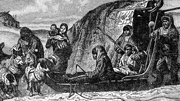 Inuit family Inuit family with 6 adults & 2 kids in front of a shelter. 3 are sitting in a sled pulled by 4 dogs.
