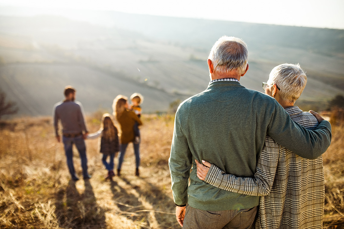 A group of people of diverse ages walking together outside.