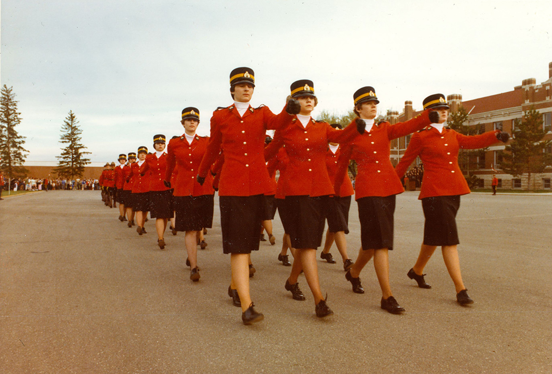 A group of female RCMP officers marching forward.