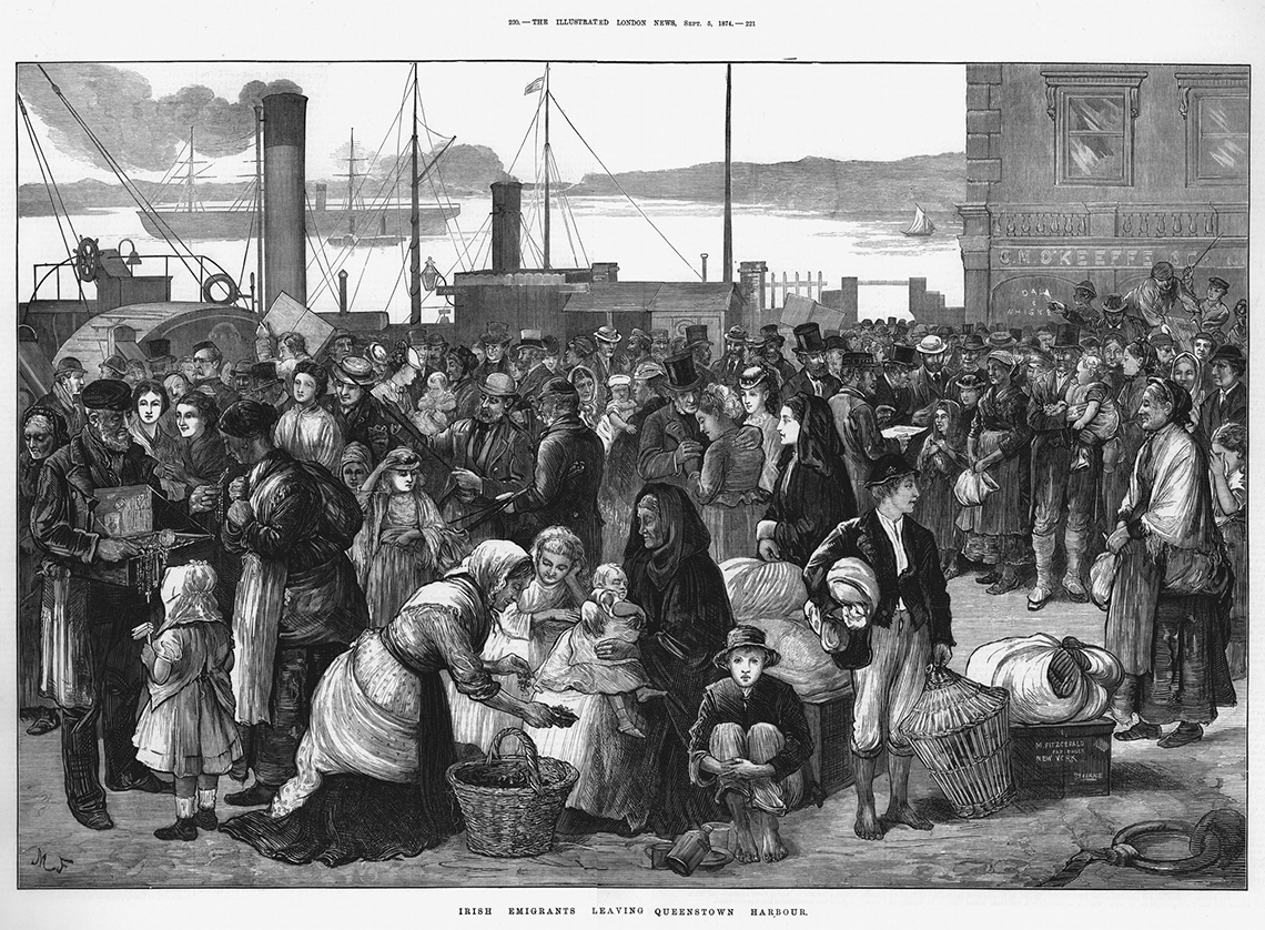 This image shows hundreds of people gathered on a dock with ships in the background.