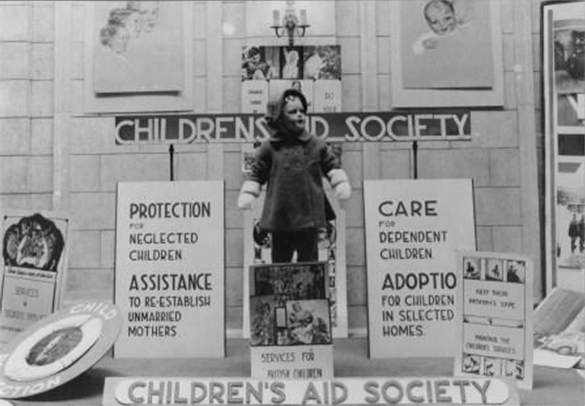 Children’s Aid Publicity display with signs that call for the protection of neglected children.