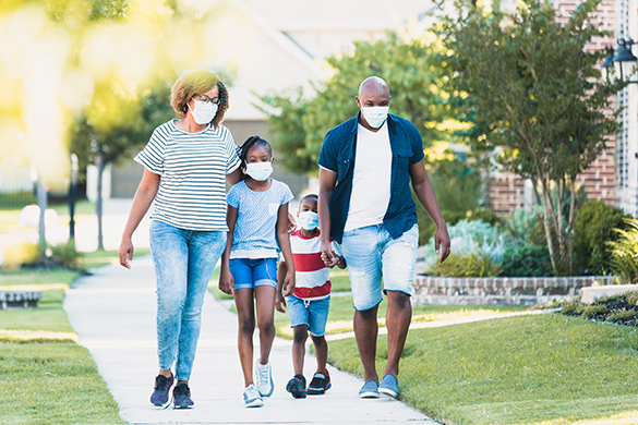 Walking Outdoors A family is spending some time walking in the neighborhood.