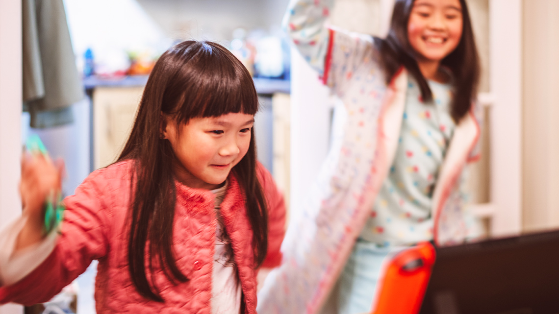 Two children dancing happily.