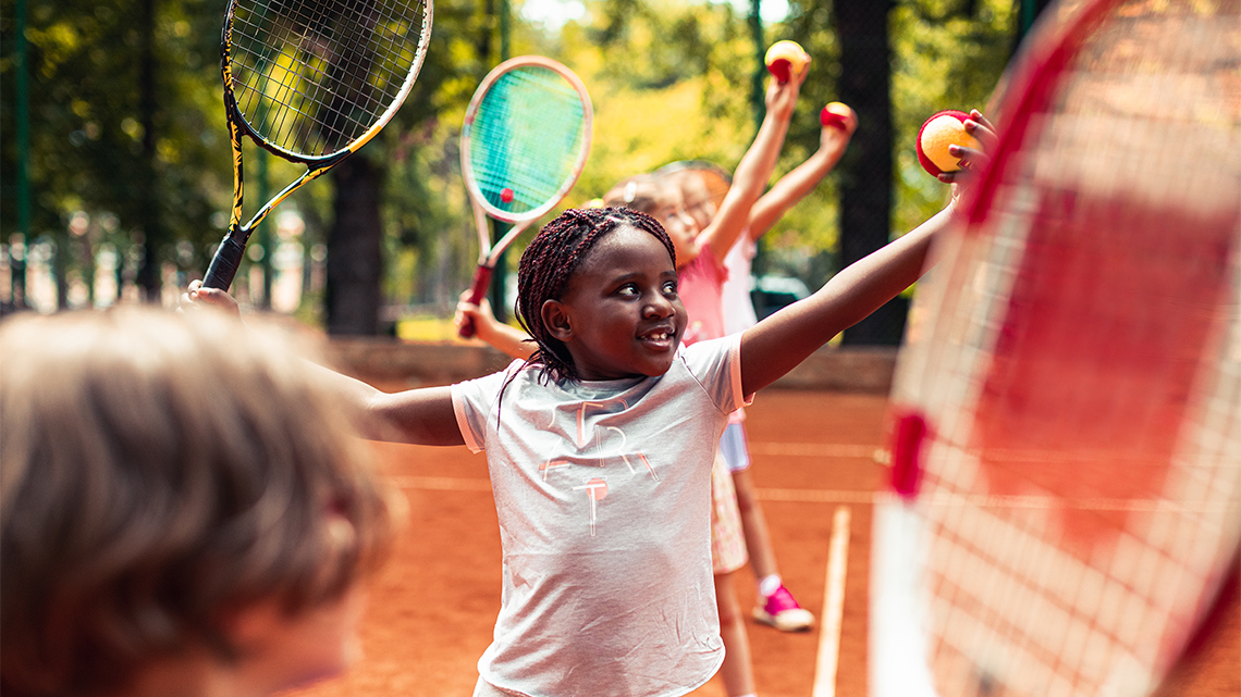 People playing tennis with a racket and tennis ball