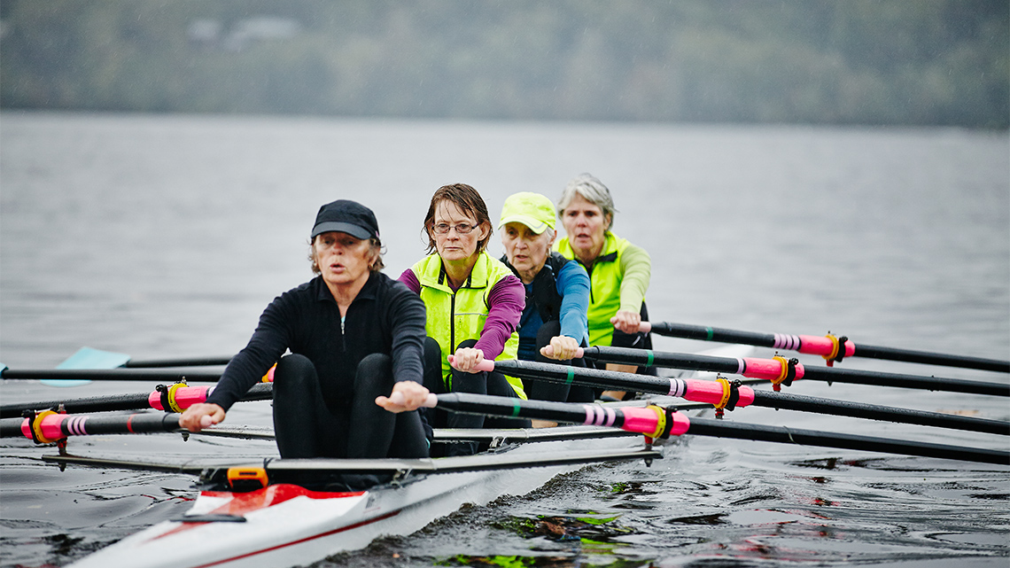 A team of people rowing a boat.