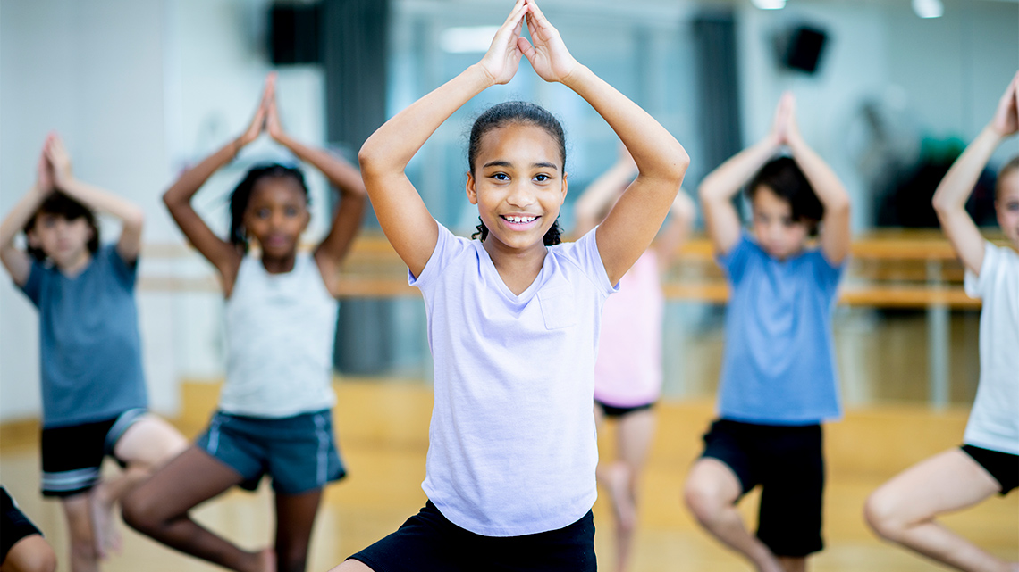 A group of children in a yoga class.