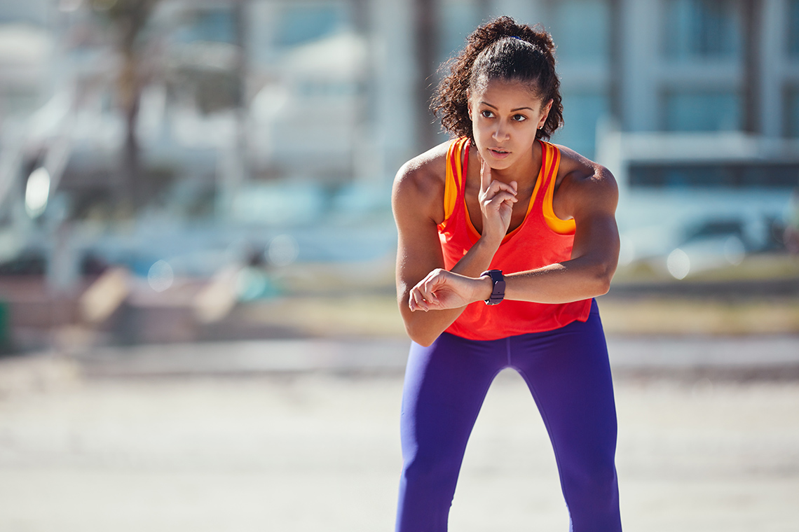 A runner checks their carotid artery and counts their heart beats.