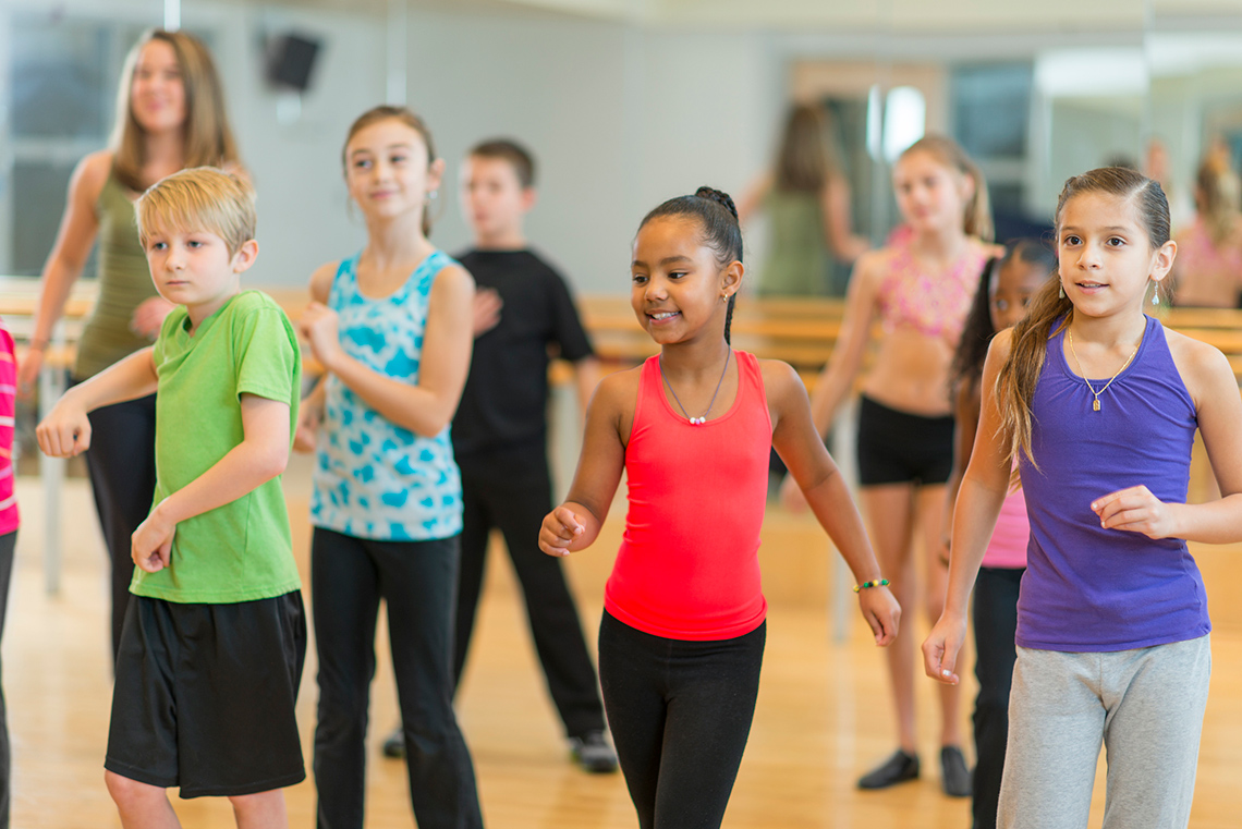 A group of kids participating in an exercise class.