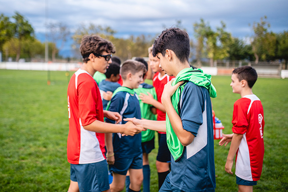 Soccer players shaking each other hands.