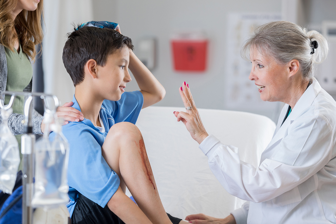 Child visiting the doctor to check for injuries and a concussion.