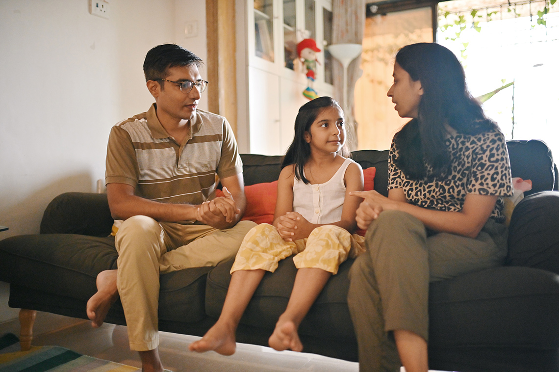 Adults having a respectful conversation with their child.