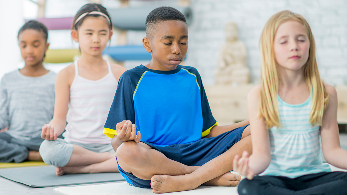 A group of children meditating.