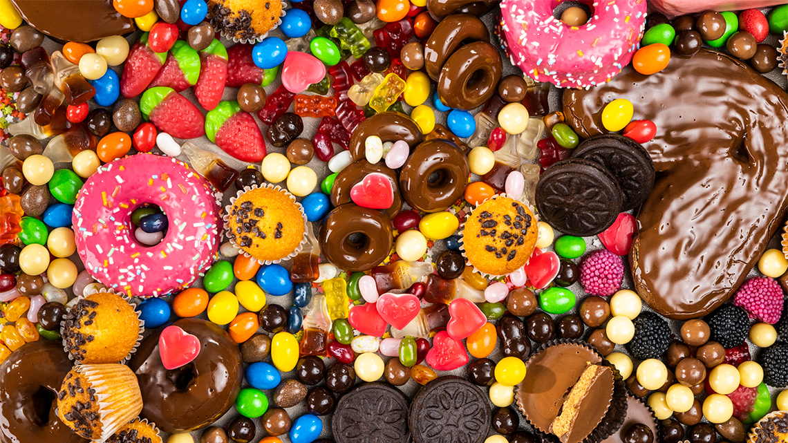 Various donuts, candies, cupcakes, chocolates, and cookies.