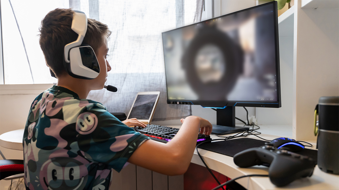 A child playing a violent video game on the computer.