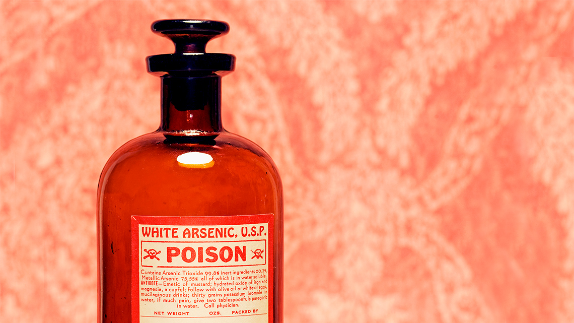 A bottle with a label that says “White Arsenic U.S.P. POISON” with two small images of skulls and crossbones.