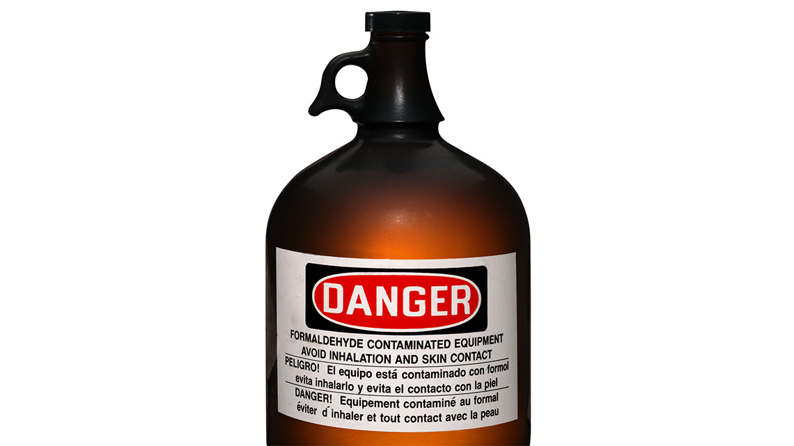 A large jug of formaldehyde with a label that says “Danger” on it.