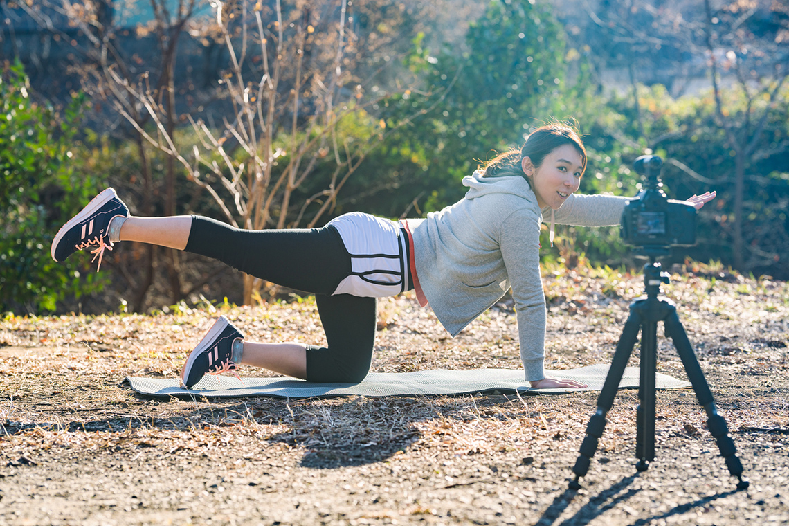 An adult balancing on one knee with the other one stretched.