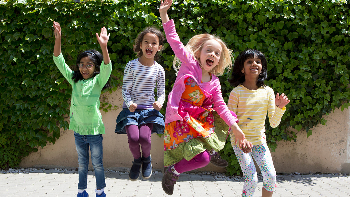 A group of children are actively moving, they are jumping in the air.