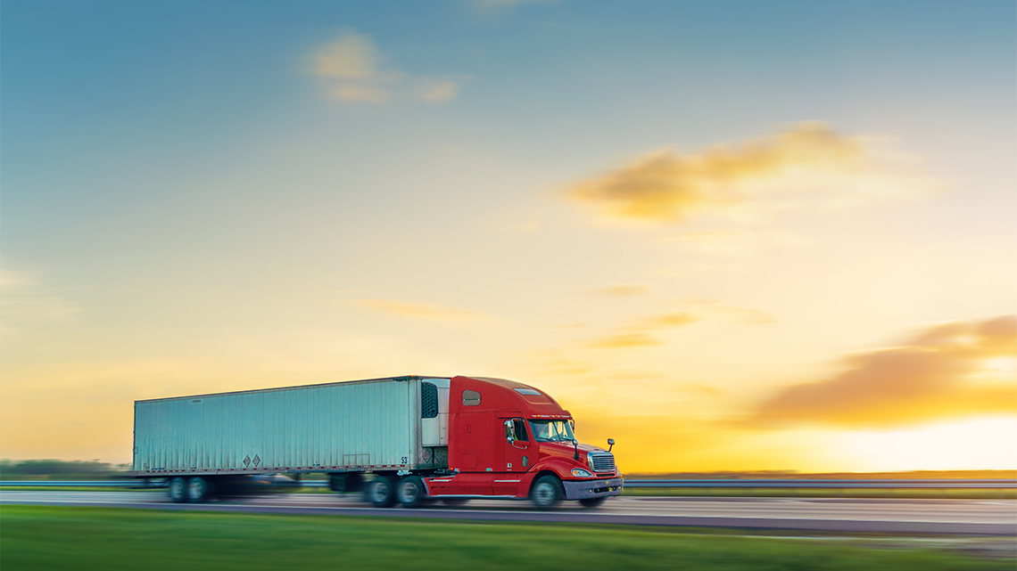 A transport truck driving down the road.