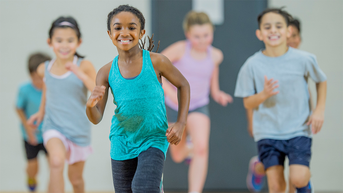 Children running in a gym.