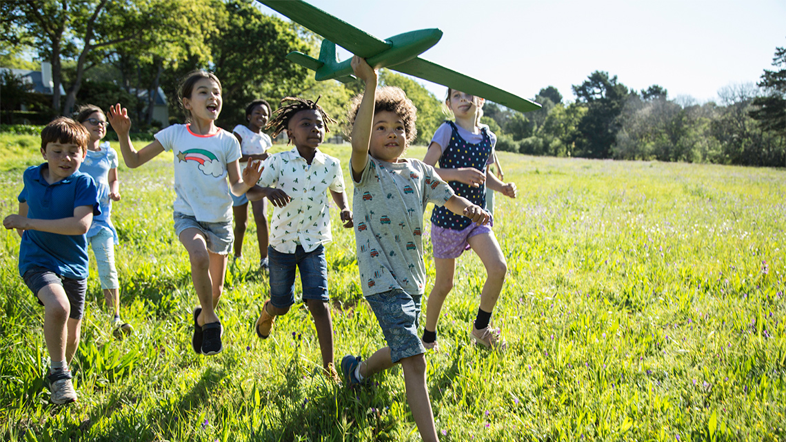 A group of children running outside.
