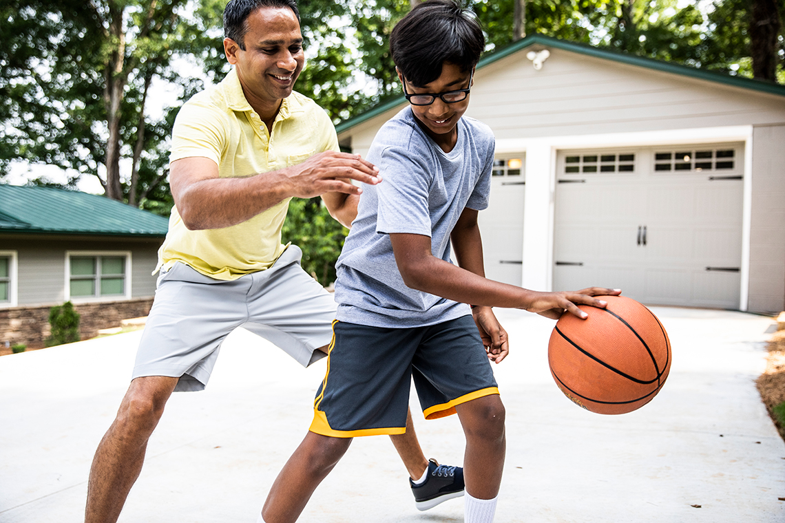 Two people are playing basketball.