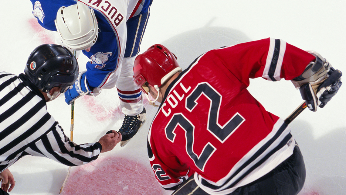 Ice hockey is played on an ice rink with skates, hockey sticks, and pucks.