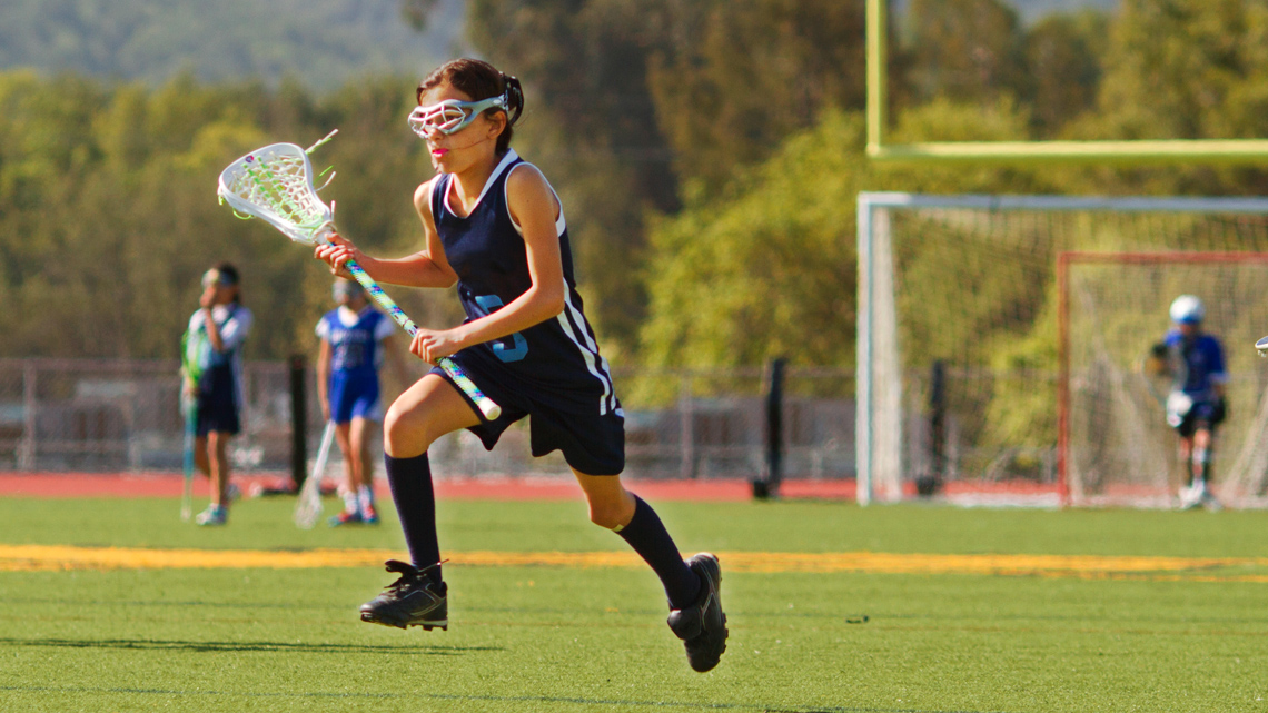 A lacrosse player on a field.