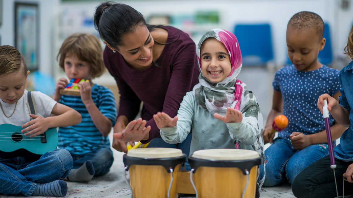 A child drumming on two drums.