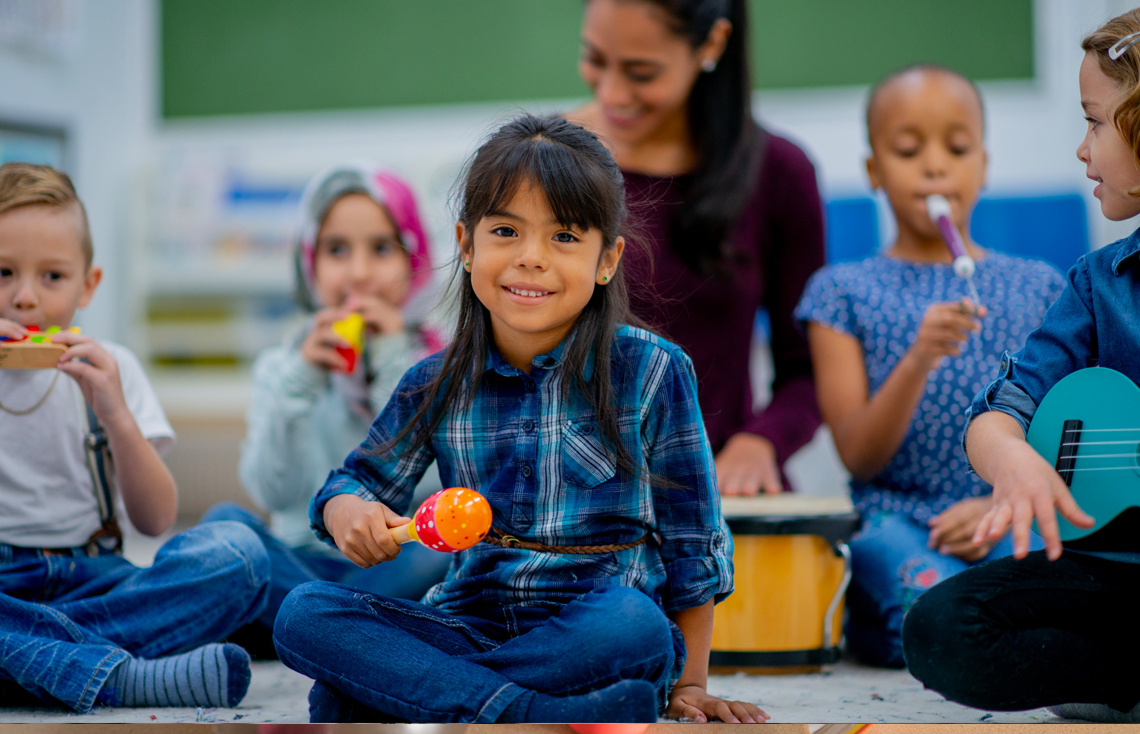 A child shaking a maraca.