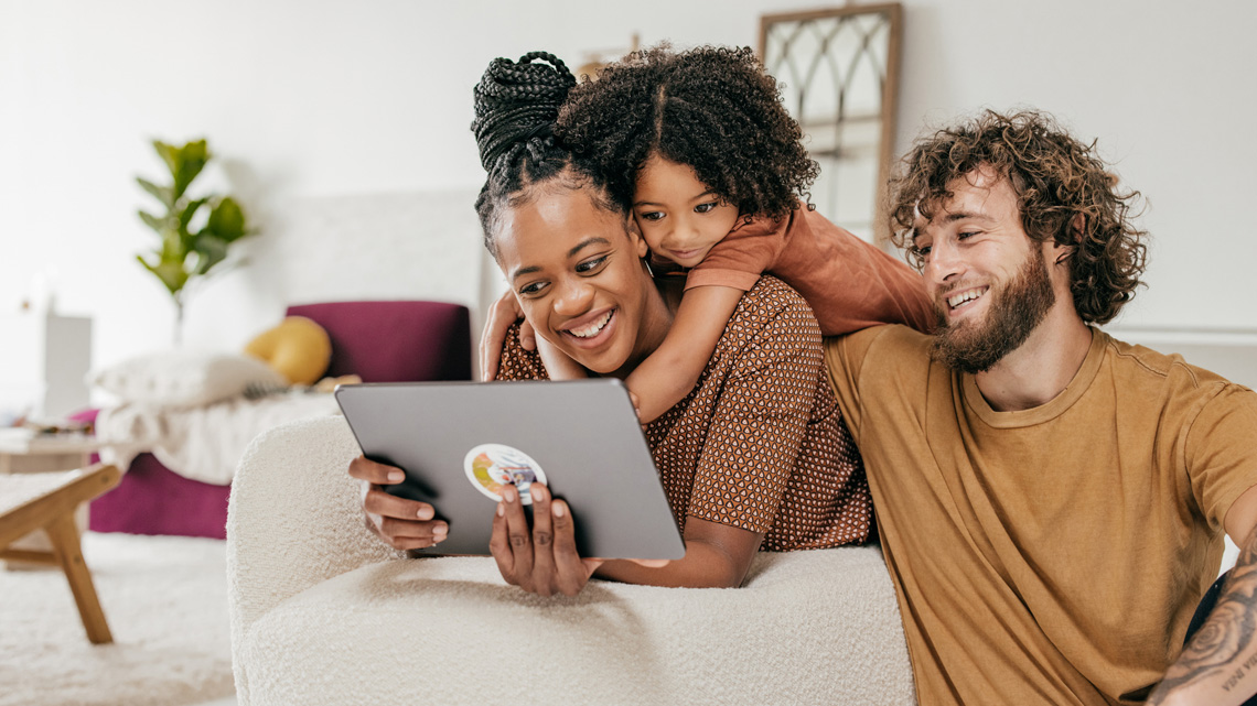 A family sitting on the couch together.