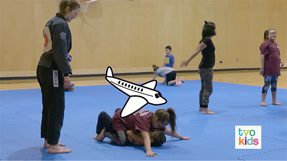 Natalya and Adriana are in a Jui-jitsu class practicing with others.