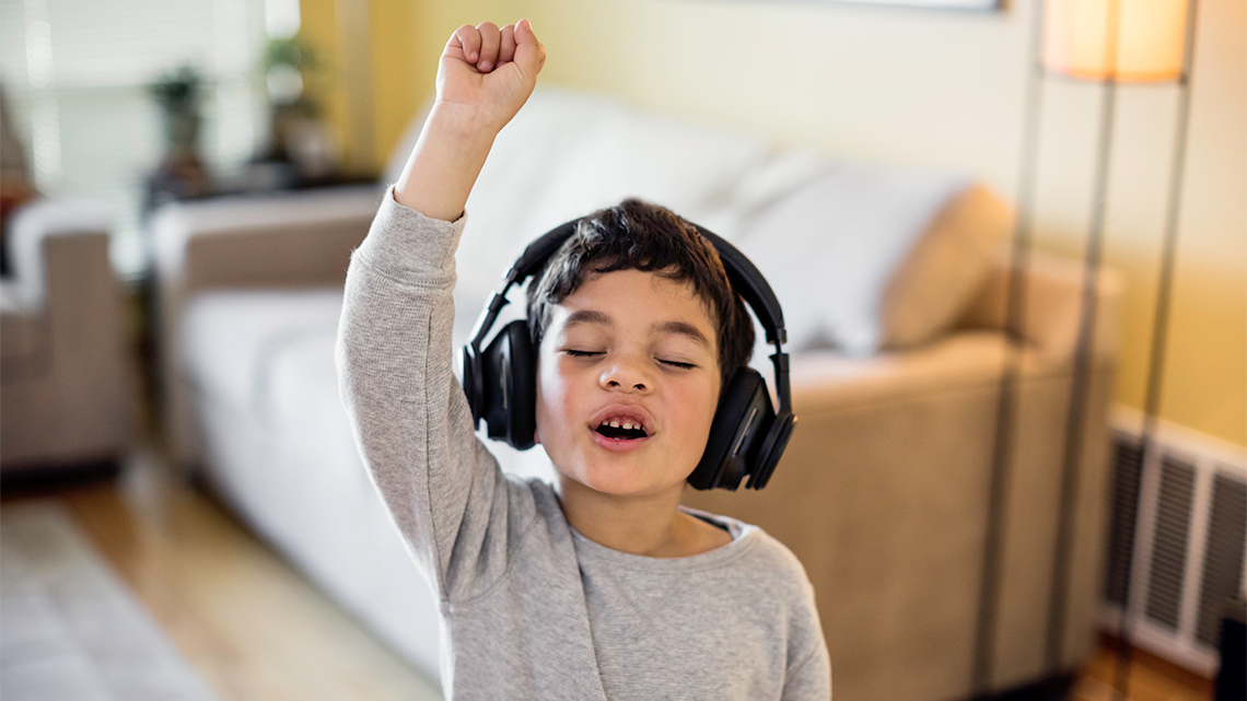 Child listening to music with headphones on
