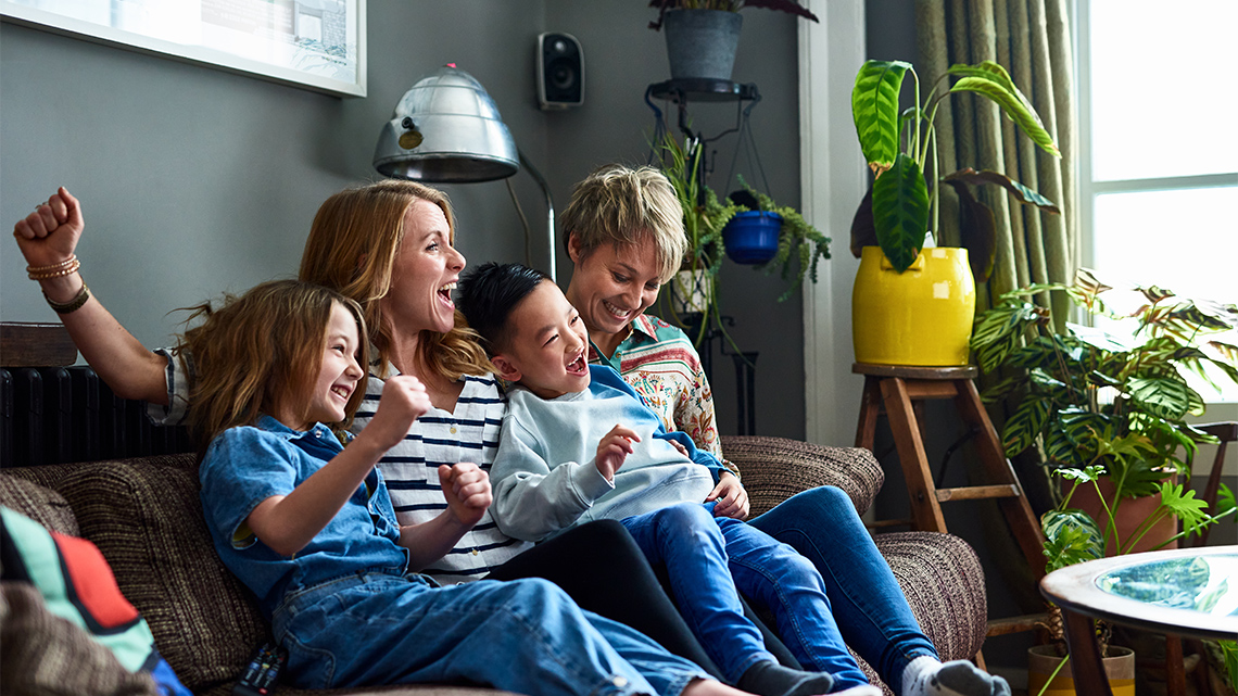 A family sitting on the couch together.