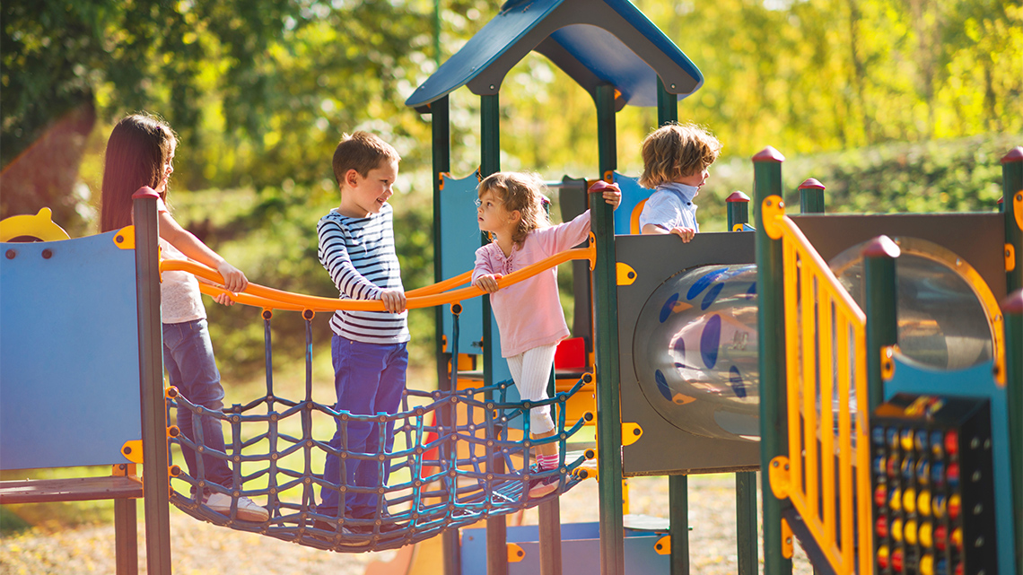 A group of children playing together on a playground.